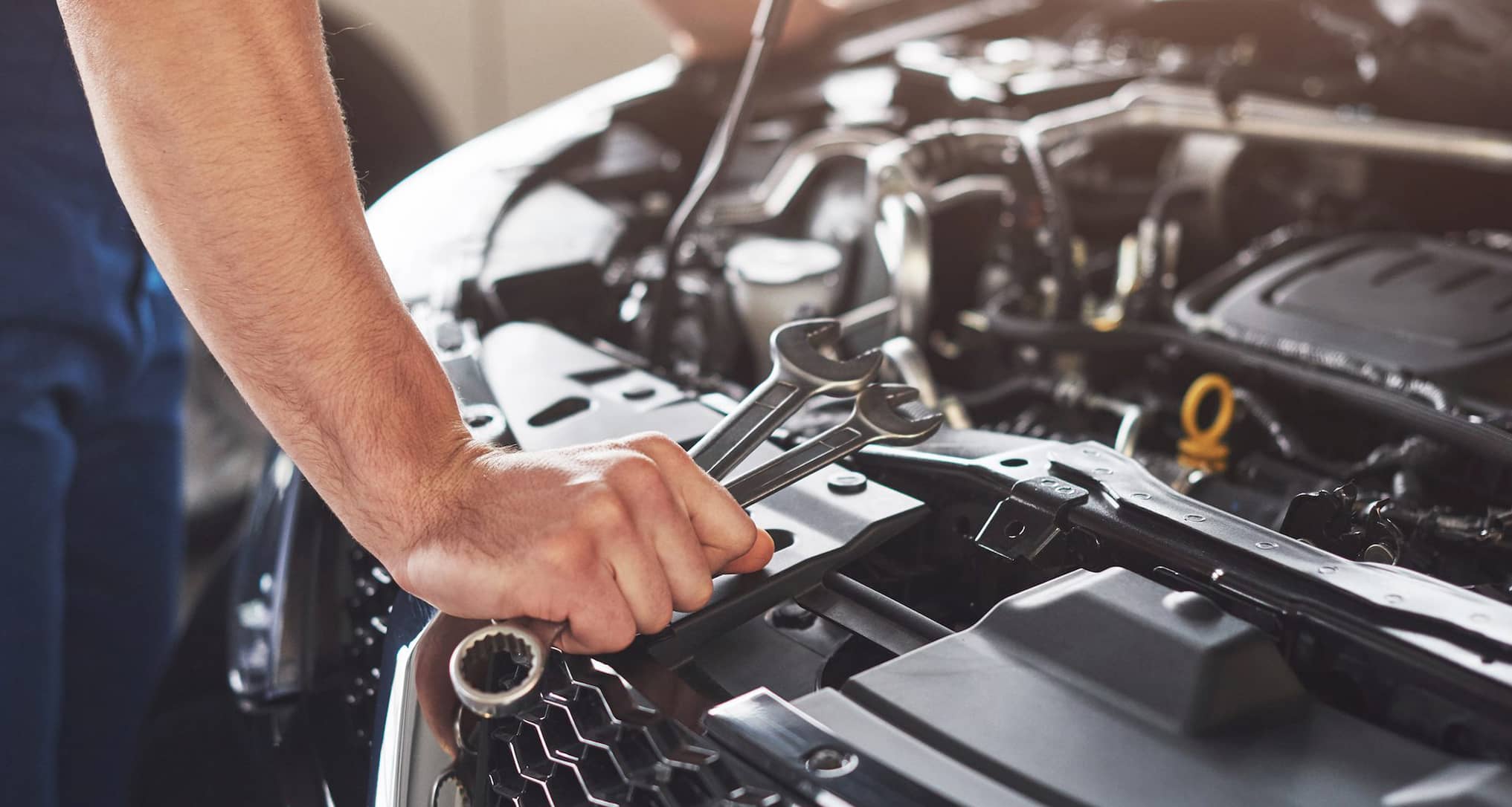 Person fixing car engine