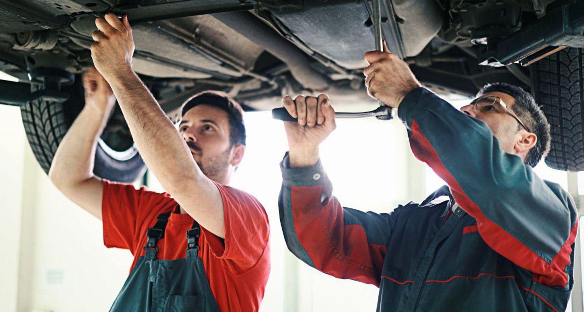technicians working on car