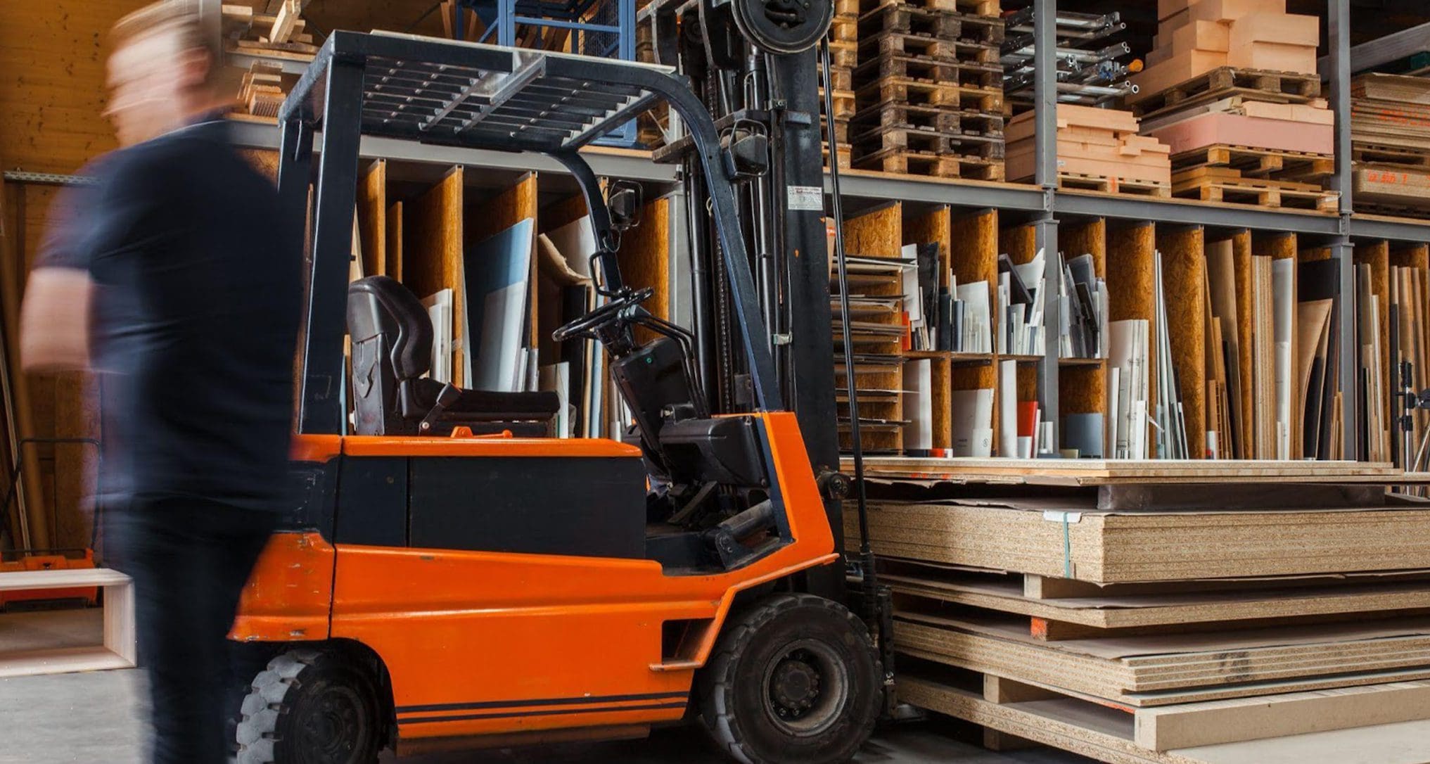A worker manning a forklift