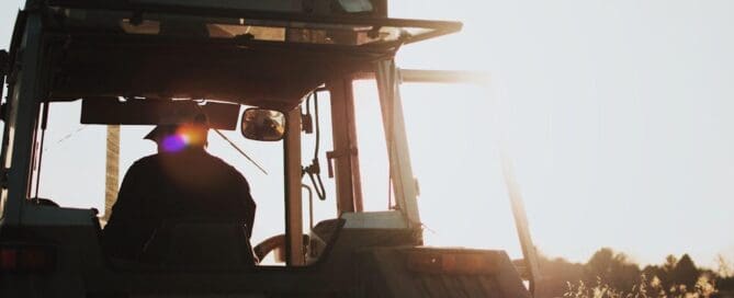 tractor riding into the sunset