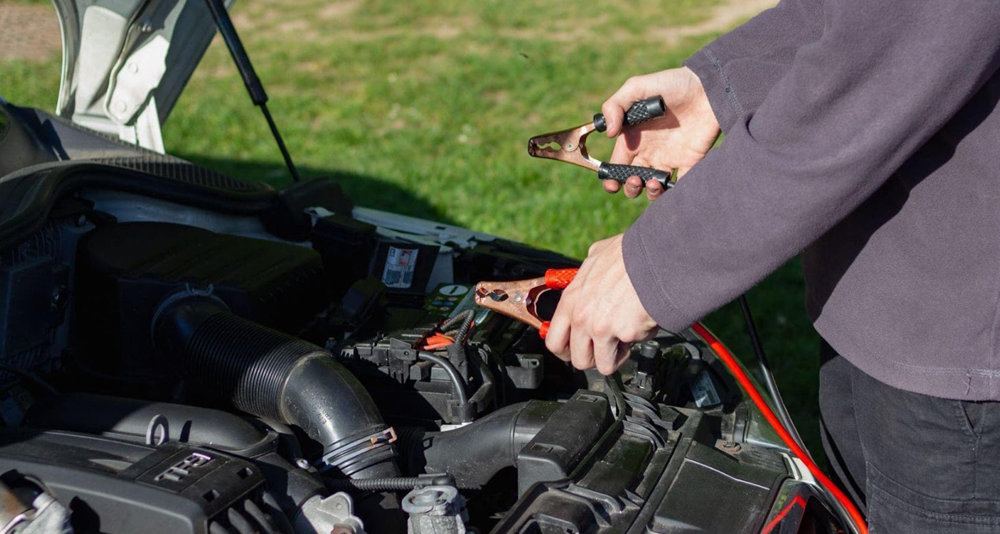 person jumping car battery