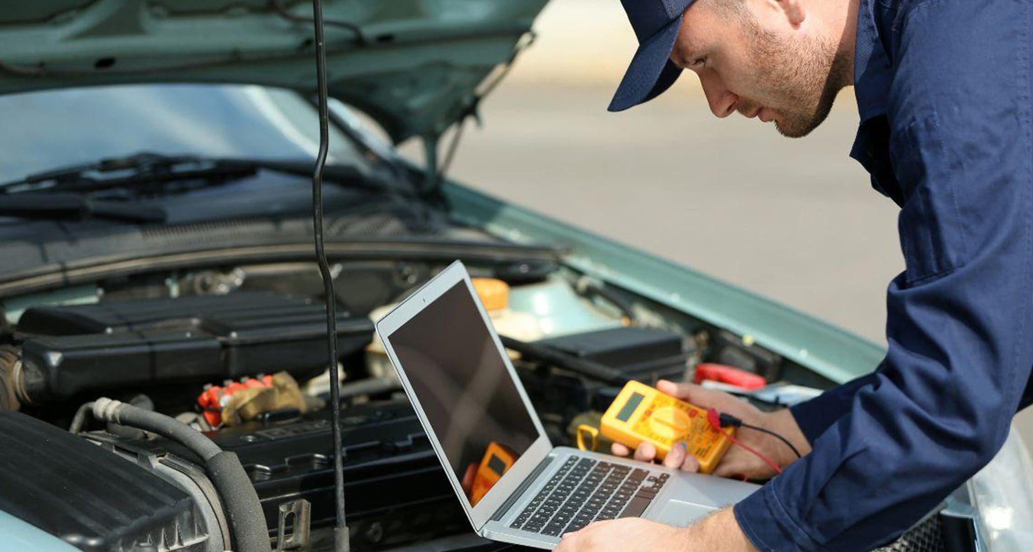 tech diagnosing sedan