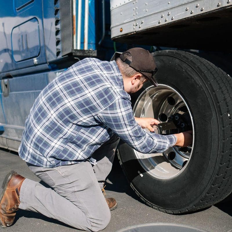 truck driver fixing tire truck driver fixing tire