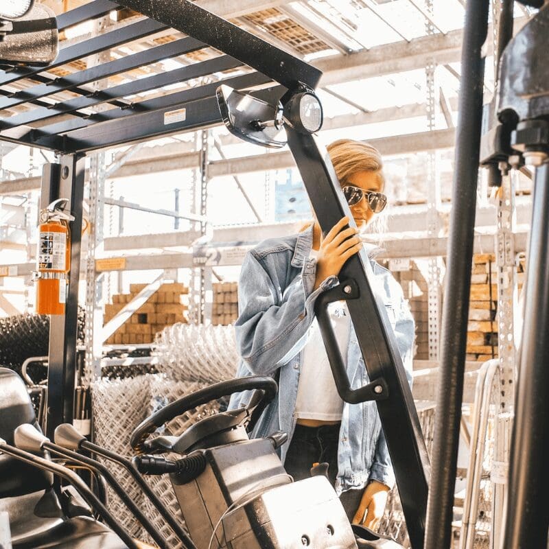 A woman behind a forklift