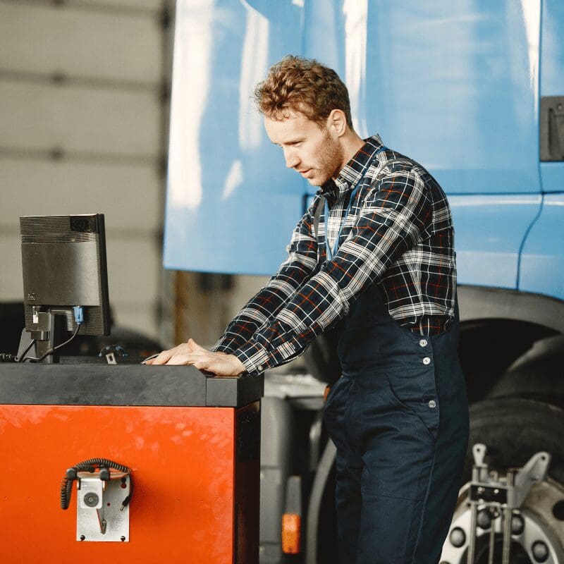 driver-checks-goods-man-uniform-truck-garage truck driver checks vehicle reporting data