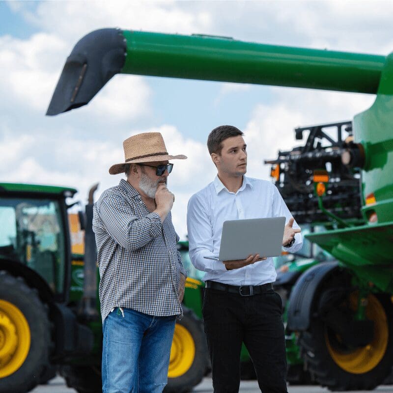farmer with diagnostic technician guiding on software