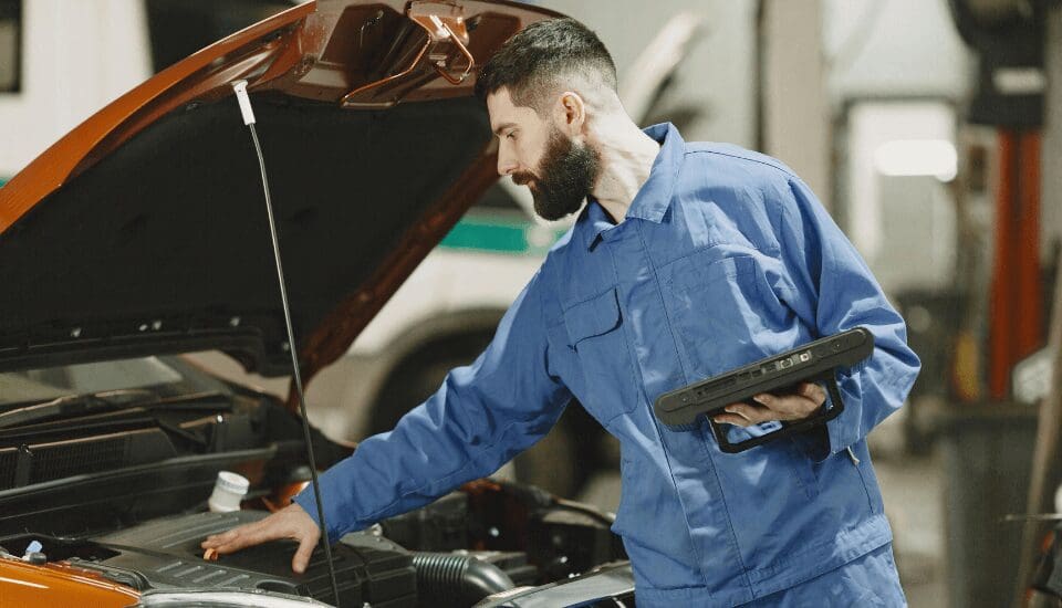 trailer diagnostic technician inspecting diesel engine