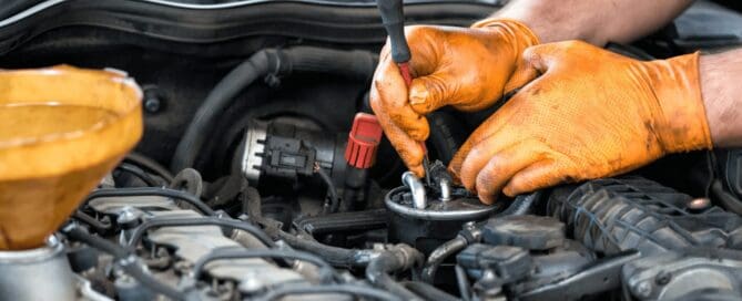 auto mechanic cleaning fuel injector