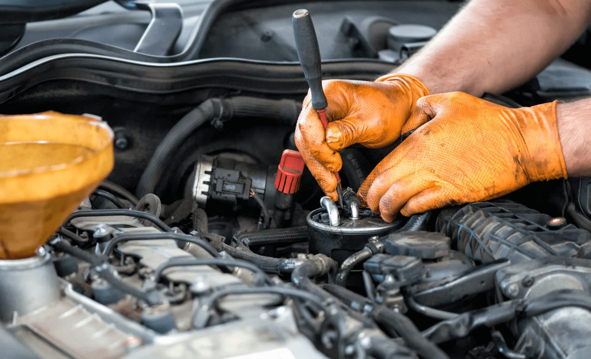 auto mechanic cleaning fuel injector