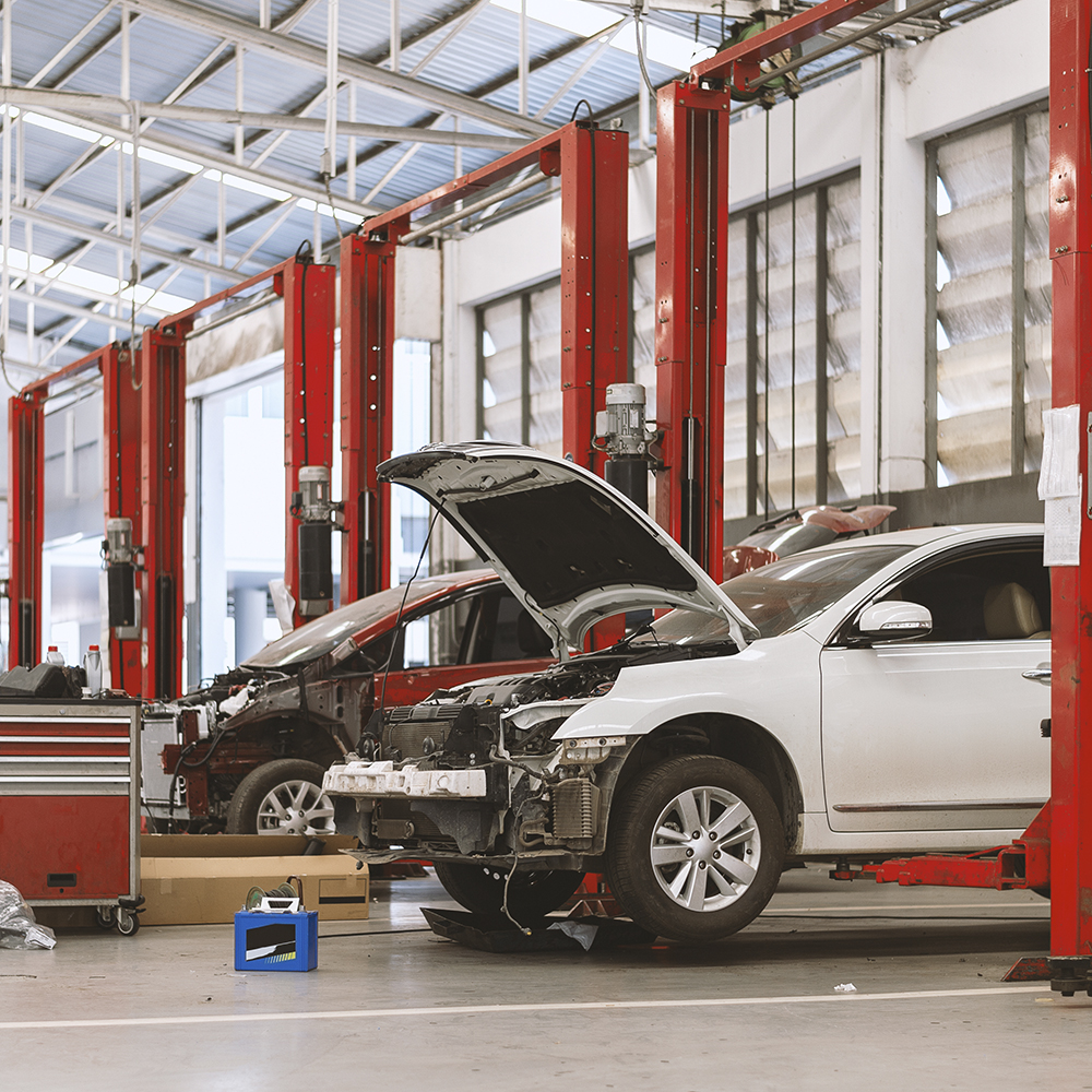 car in shop bay getting work