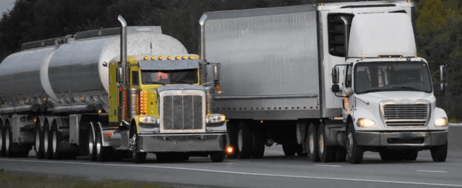 two different trailer trucks racing on the highway