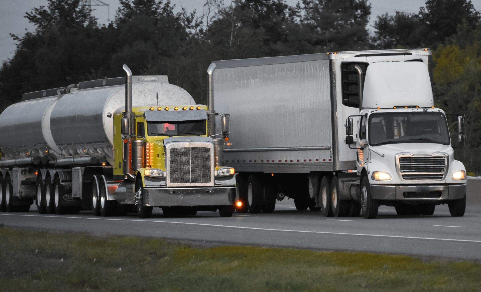 two different trailer trucks racing on the highway