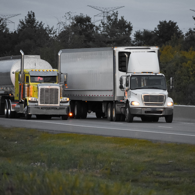 semi trucks passing each other on the highway
