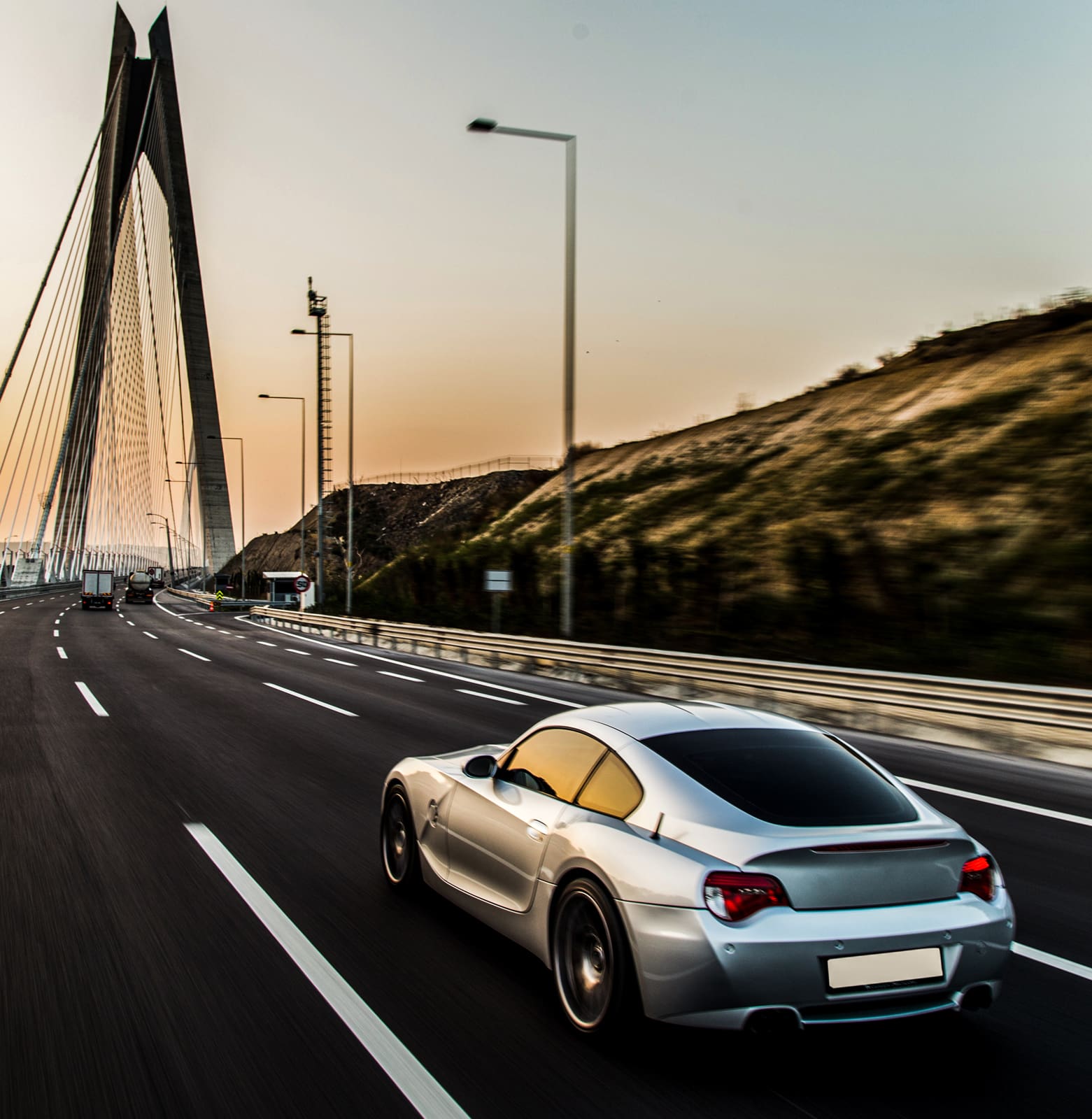 car driving onto bridge